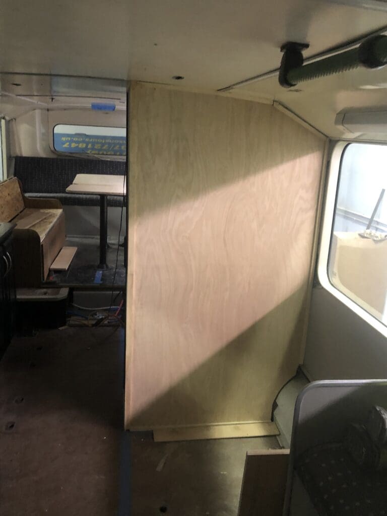 A room with a wooden wall and some tables