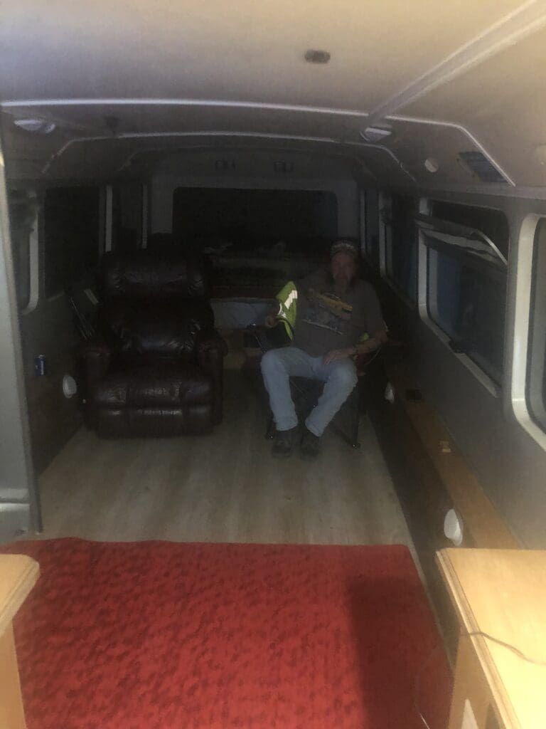 A man sitting in the middle of a room.