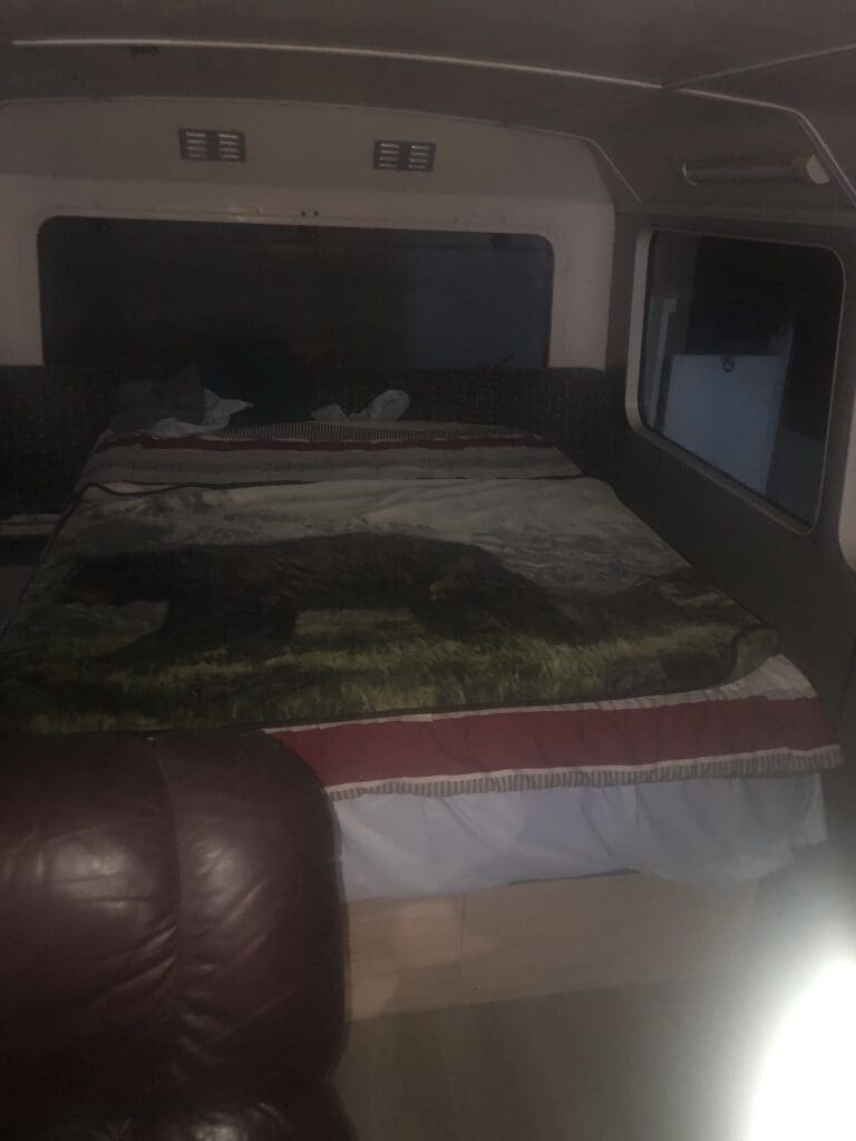 A bed with two cats laying on it