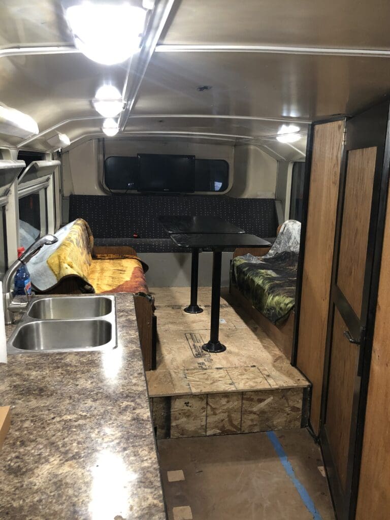 A kitchen with a sink and a refrigerator